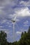 Technology and Nature. Wind turbine above a forest canopy