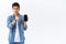 Technology, online lifestyle concept. Portrait of angry judgemental asian boyfriend pointing at mobile phone, showing