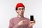 Technology and people concept. Close-up portrait fascinated and impressed good-looking young man in red beanie and