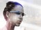 The technology to take over the city. Multiple exposure shot of a young businesswoman wearing smartglasses superimposed