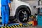 Tecnician setting balancing center wheel of car / Suspension Alignment