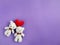 Teddies with red heart shaped in purple background. Stock photo.