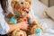 teddy bear with colorful bandaids and a person comforting it