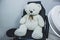 Teddy bear in cosmetic chair, lamp magnifier for beautician , beautician workplace, black chair beauticia