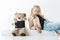 teddy bear with digital tablet and adorable stylish child