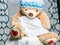 A teddy bear full body portrait  wearing a shower cap and a towel