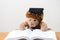 Teddy bear graduate reads a book.back to school