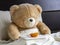 Teddy bear having healthy breakfast in bed