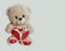 Teddy bear with a heart on a gray background with place for text. banner, valentines day, love, toy, gift