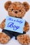 Teddy bear holding blue sign saying It`s a baby Boy
