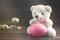 Teddy Bear holding an Easter egg, chicken, wood background