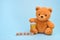 Teddy bear holding honey pot