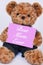 Teddy bear holding pink sign saying Best Mom Ever