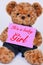 Teddy bear holding pink sign saying It`s a baby Girl