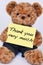 Teddy bear holding a sign that reads Thank you very much isolate