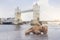 Teddy bear lying alone with blurry london tower bridge background, The forgotten bear sitting by the river, lost property, Lonely