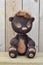 Teddy-bear Mocca against wooden boards