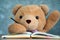 Teddy Bear sitting on a desk And raise your hand when asked. Communication to school children. Give Teddy Bear a Student