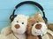 Teddy bear toy headphones plush listening on wooden background