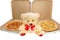 A Teddy bear with two pizzas
