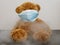 Teddy bear type covid 19 coronavirus mask surrounded by smoke