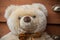 Teddy bear on wooden chest of drawers background