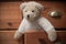 Teddy bear on wooden chest of drawers background