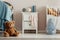 Teddy bear on the wooden floor of scandinavian baby bedroom interior