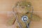 Teddy bear on wooden floor with stethoscope with earpieces in ea
