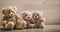 Teddy bears family sitting on a wooden background