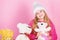 Teddy bears help children handle emotions and limit stress. Kid little girl play with soft toy teddy bear on pink