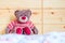 Teddy dream concept: Teddy bear is sitting in a wooden bed