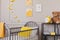 Teddy and yellow clock on industrial metal shelf in cute baby bedroom