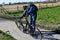 Teeange boy checks his bicycle