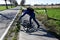 Teeange boy checks his bicycle