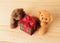 Teedy bear with gift box on wooden backgrounds