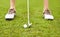 Teeing off a hole. an unrecognizable woman out playing golf on a golf course.