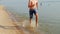 Teen 15 years running on the beach on the water