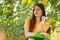 A teen age girl is learning in the garden under a lemon tree