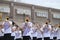 Teen band playing trombones in a small town parade in America