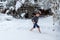 Teen barefoot runs in the snow. Winter day. Hardening