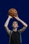 Teen basketball player. The guy in the black t-shirt holds the ball in his hands and prepares to throw it up. Template for the