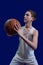 Teen basketball player. The guy in the white T-shirt holds the ball in his hands and is preparing to throw it. Template for the