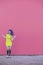 Teen beautiful woman with purple afro hair dancing with a cool yellow dres