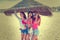 Teen best friends girls under thatch umbrella