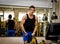Teen bodybuilder exercising pecs muscles with gym equipment