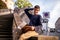 Teen with a book sitting on the concrete stairs balustrade