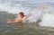 Teen boy is body surfing in the ocean