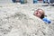 Teen Boy Buried in Sand