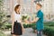 Teen boy congratulates girl with bouquet of flowers, outdoor portrait couple happy youth